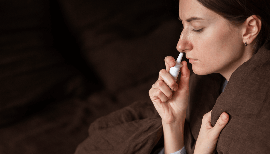 A woman uses an electronic device to discreetly blow her nose, showcasing modern technology in personal care